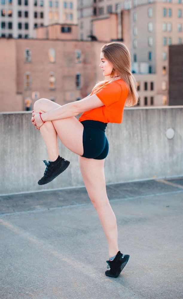 Tiffany stretching on a rooftop